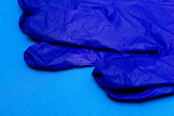 blue medical surgical gloves on a blue background close-up