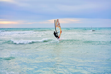 man goes windsurfing on the sea