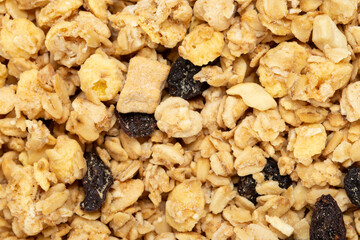 Healthy breakfast. Oatmeal background with dried grapes. Musli is healthy food. Space for text.