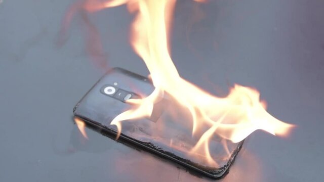 Mobile phone explodes and burns. Cell Phone explosion and fire .Smart Phone Danger from over use or bad manufacturing. Burning up my phone concept.