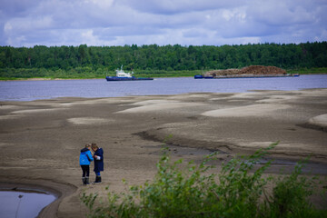 summer river, river, forest BEYOND the river, fishing spot, spring, sandy beach, ship on the river, barge dragging trees on the river, cargo ship, children playing on the shore