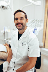 Fototapeta premium Happy young dentist in his clinic