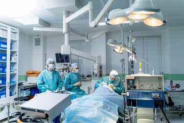 Team of Surgeons Operating. Modern equipment in operating room.