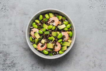 Shrimp salad with black rice, edamame beans, avocado. Healthy nutrition with seafood 