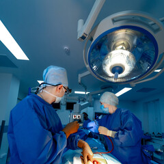 Medical team performing surgical operation in modern operating room