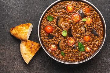 Stew vegetables and legumes for healthy diet. Lentils, eggplants and tomatoes in bowl.  Vegan food