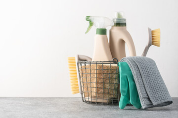 Brushes, sponges, rubber gloves and natural cleaning products in the basket.  Eco-friendly cleaning products - Powered by Adobe