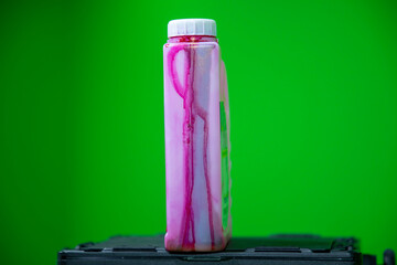 Close up view of red colored ink bottle which is used in color printer. 