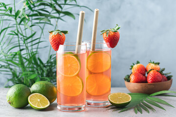 Strawberry lemonade with lime. Refreshing summer drink in tall glasses 