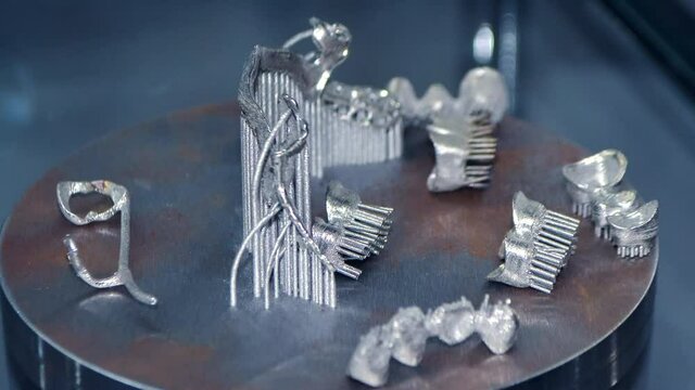 3D model of human teeth printed on metal 3d printer close-up. Technology selective laser melting, sintering metal. New prototyping additive technology. Medical stomatological dental crowns bridge