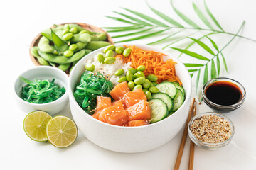 Poké bowl with fresh salmon, rice, chukka salad, edamame beans, carrots and cucumber. Bowl of healthy food on white background 