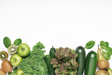 Green vegetables, fruits and salad. Kiwi, apples, kale salad, zucchini, microgreens, spinach, pear. Healthy eating concept