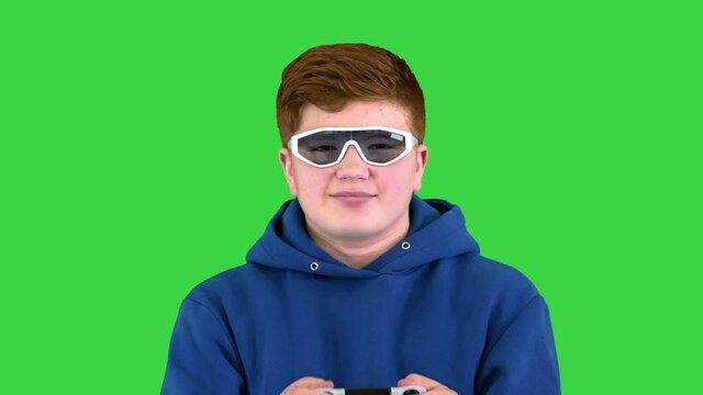 Cool Modern Kid Playing Video Game In Sunglasses On A Green Screen, Chroma Key.