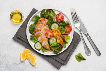 Chopped chicken breast with salad. Lettuce, tomatoes, cucumbers with poultry. Healthy eating food on white background