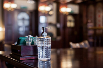 Hand sanitizer gel dispenser in cafe. Post-quarantine new normal life, social rules after coronavirus pandemic concept.   Covid-19 at public space. Selective focus