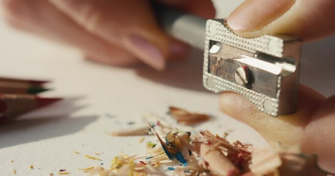 Pencil sharpener in female hands fingers macro close up slow motion