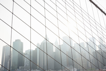 Cityscape against clear sky seen through cables