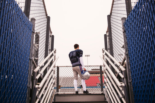 Low angle view of American football player standing against sky at stadium