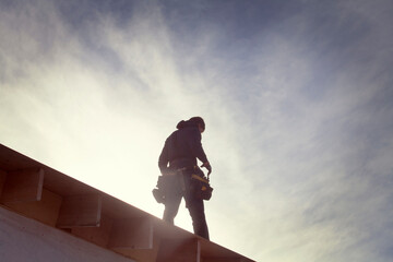 Low angle view of architecture standing on roof beam during sunny day