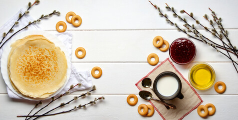 Shrovetide festival. Russian pancakes with raspberry jam, honey and sushki on white wooden background.