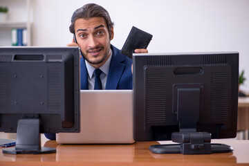 Young male employee in multitasking concept