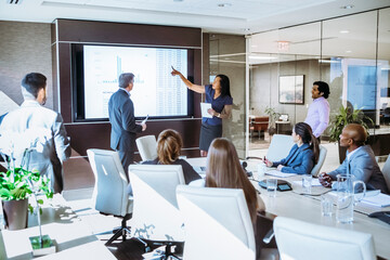 Colleagues discussing in meeting at conference room