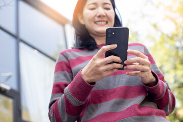using cell phone hand holding mobile texting message contact us.chatting,search internet...