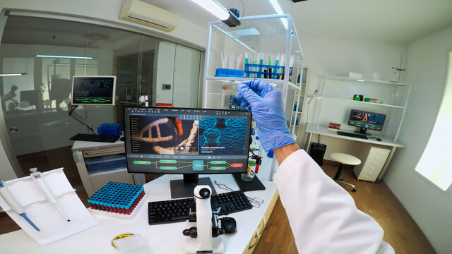 POV of scientist looking at biological samples under microscope typing on pc. Team of chemists working in lab, examining virus evolution using high tech for scientific research of vaccine development. - Powered by Adobe