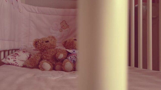 Close up Two soft bears toys at children's bed. baby cot 
