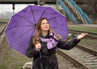 Woman with umbrella at railway