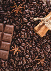 chocolate, coffee beans, anise and cinnamon on wooden background