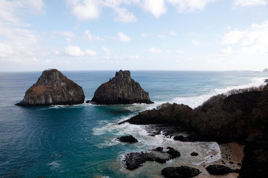 Scenic view of rock formations in sea at Fernando de Noronha against sky