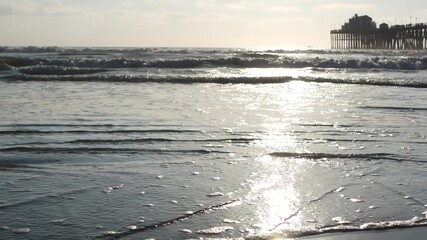 Wooden pier on piles, silhouette at sunset, California USA, Oceanside. Waterfront resort, pacific...