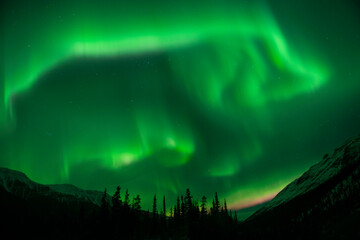 Idyllic view of mountains against aurora borealis at Northern Rocky Mountains Provincial Park