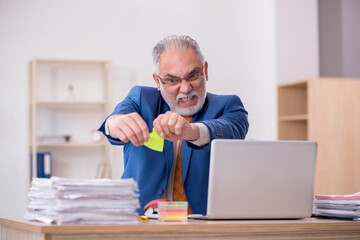 Old businessman employee sitting in the office