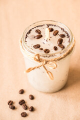 DIY concept. Handmade scented candle with coffee beans in a glass jar