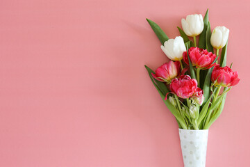 Fresh flower composition, bouquet of different types of tulips, isolated on pink background. International Women's day, mother's day greeting concept. Copy space, close up, top view, flat lay.