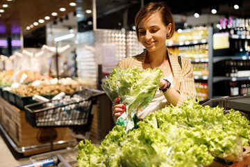  young girl are shopping at a supermarket. girl are choosing drinks. Alcohol drinks