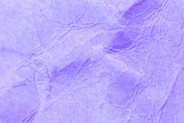 Crumpled purple paper background. Real macro battered texture. Close up photo.