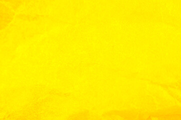Crumpled yellow paper background. Real macro battered texture. Close up photo.