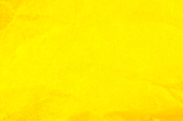 Obraz premium Crumpled yellow paper background. Real macro battered texture. Close up photo.
