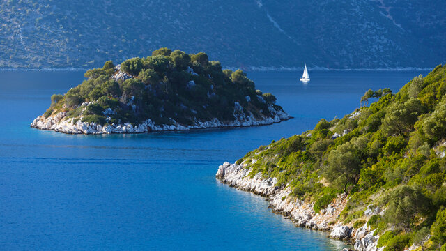 Sailboat and an islet in the Molos Gulf in Ithaca island, Greece.