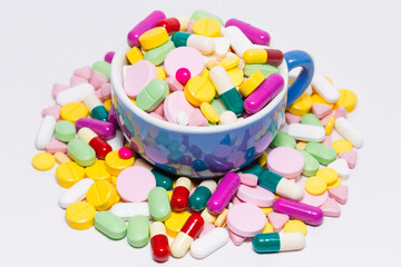 Medical drugs in a blue coffee cup.