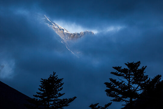 Mount Everest seen though the clouds, Khumbu Region,  Nepal  Himalay