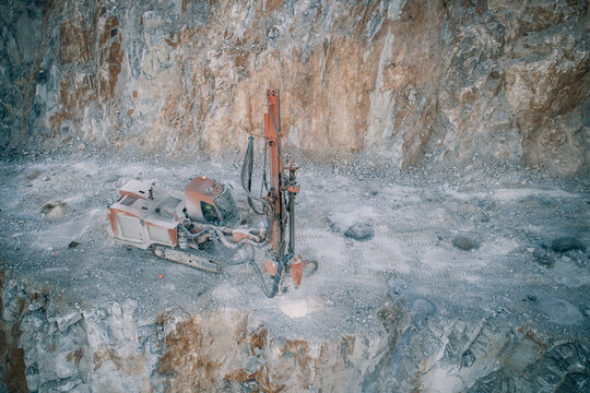 drilling machine working over rocks