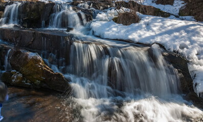 A small waterfall on the river in the spring