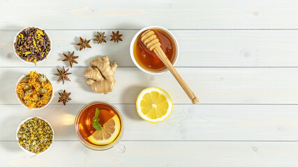 Cup of freshly brewed fruit and herbal tea with mint, lemon, and ginger. Healthy concept. Trend hard shadows