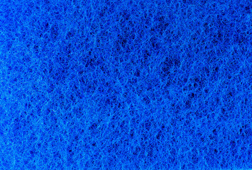 Fototapeta na wymiar Blue sponge texture background. Close up, macro photo.