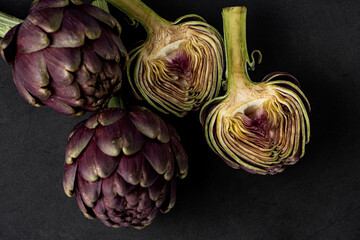 fresh artichokes close-up on dark gray background