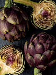 fresh artichokes close-up on dark gray background